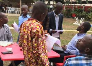 Youth evaluators, supported by mentors, doing practice interviews at the University of Kinshasa